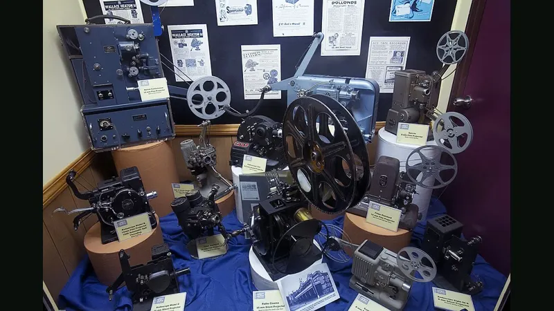 Display of vintage film projectors and memorabilia