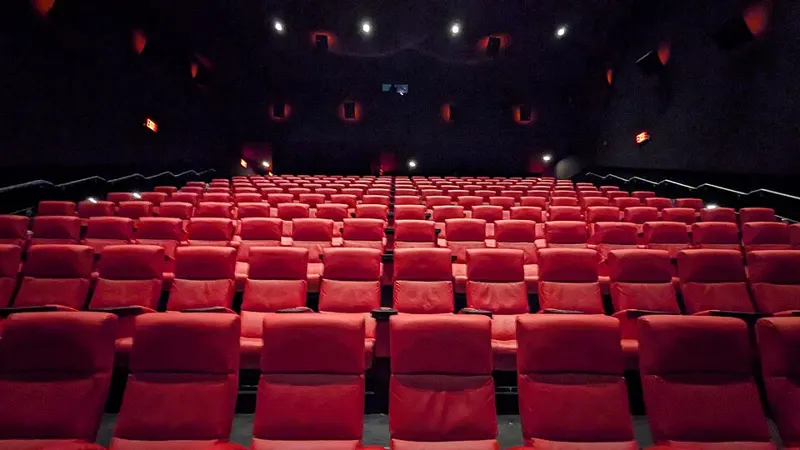 Empty movie theater with rows of seats